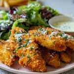 Crispy breaded chicken tenders served with a side salad and dipping sauce, perfect chicken for busy weeknights.