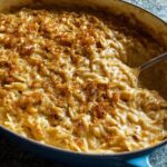 Close-up of a creamy orzo dish in a blue pan, a one-pan dinner recipe with a golden breadcrumb topping.