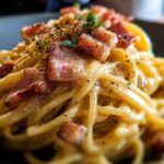 Close-up of spaghetti carbonara with crispy bacon pieces and black pepper, a perfect example of best dinner recipes 2025.