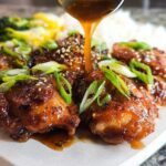 Pouring glaze over delicious chicken thighs, a perfect meal-prep option for busy weeknights.