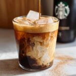 Espresso being poured over ice and oatmilk to create an Iced Brown Sugar Oatmilk Shaken Espresso.