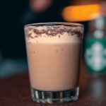 A close-up of a perfect Starbucks drink with creamy foam and chocolate dusting, hinting at what makes perfect Starbucks drinks.