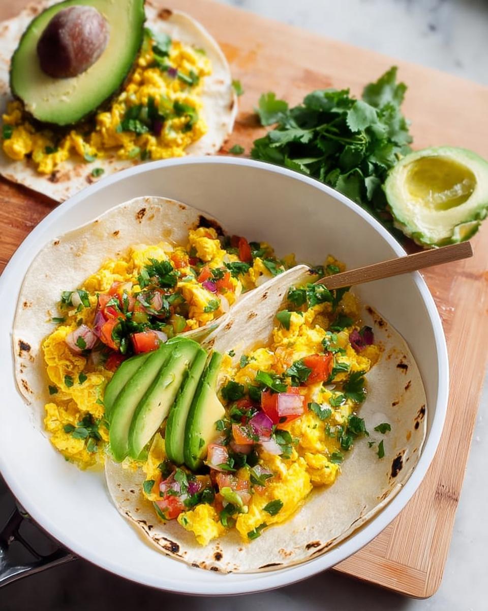 Scrambled egg breakfast tacos topped with pico de gallo and avocado slices, part of Ultimate Breakfast Ideas.