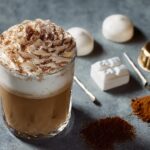 A Starbucks drink topped with whipped cream and cocoa powder, part of the Ultimate Starbucks Drinks Guide.
