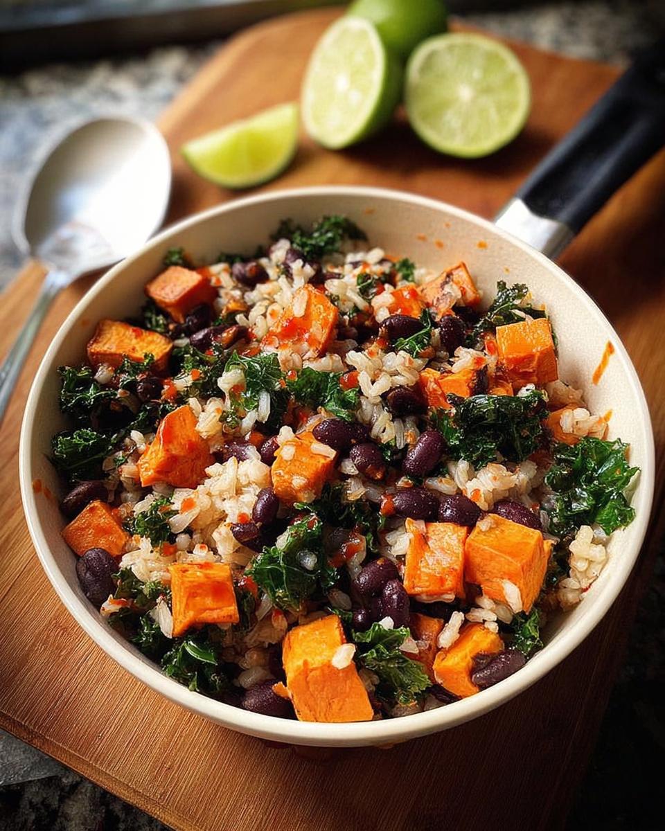 A vibrant bowl filled with rice, diced sweet potatoes, black beans, and kale, perfect for easy dinner recipes.