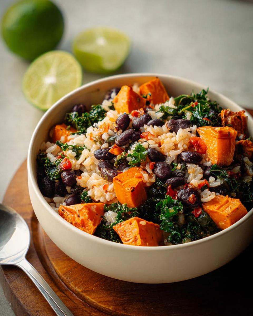 A vibrant bowl filled with rice, black beans, kale, and roasted sweet potato chunks, perfect for easy dinner recipes.