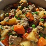 Close-up of a hearty beef stew with potatoes, carrots, peas, and cranberries, a perfect example of quick stuffing recipes.
