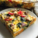 A slice of breakfast casserole with sweet potato, spinach, sausage, and red peppers, part of meal prep ideas recipes.