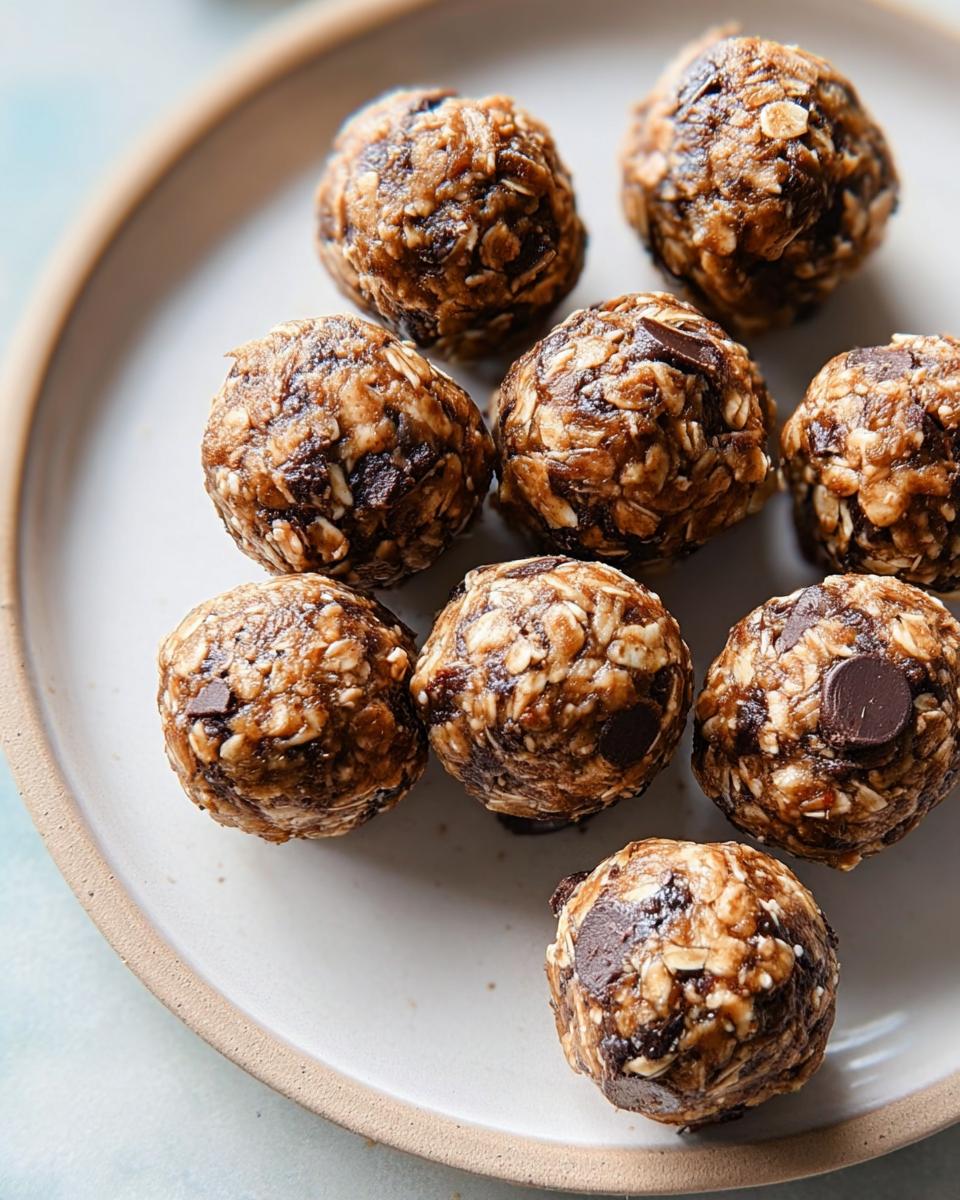 Close-up of no-bake energy bites, a healthy breakfast idea, made with oats, chocolate chips, and dates.