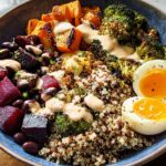 A vibrant breakfast bowl featuring quinoa, roasted vegetables, black beans, and a soft-boiled egg, part of our popular Breakfast Ideas Recipes.