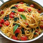 A close-up of a pasta dish with cherry tomatoes and basil, perfect for easy dinner recipes meal prep.