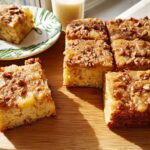 Close-up of a slice of restaurant-style apple walnut crumble cake, showcasing a moist crumb and caramelized topping.