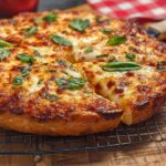 A golden-brown, cheesy pizza with fresh basil, perfect for restaurant-style pizza night at home.