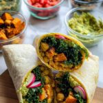 A delicious and healthy wrap, cut in half, showcasing chickpeas, kale, sweet potato, and avocado. Perfect for sandwich ideas recipes meal prep.