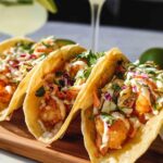 Three delicious shrimp tacos filled with crispy shrimp, slaw, and cilantro, perfect for quick shrimp recipes.