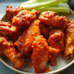 A plate of spicy, glazed chicken wings, perfect for quick weeknight meals.