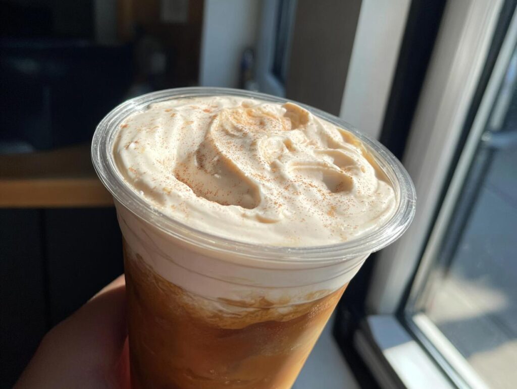 Close-up of a homemade Starbucks Pumpkin Spice Latte with whipped cream and cinnamon.