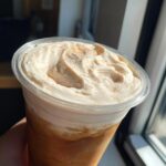Close-up of a homemade Starbucks Pumpkin Spice Latte with whipped cream and cinnamon.