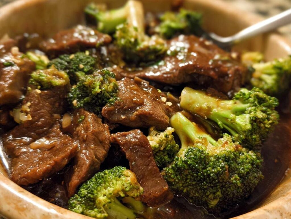 Close-up of tender slices of Chinese Beef and Broccoli coated in a rich, savory sauce.