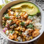 A delicious Easy Street Corn Chicken Bowl filled with rice, seasoned chicken, corn, avocado, and cilantro.