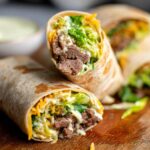 Close-up of delicious homemade Big Mac Wraps filled with seasoned beef, shredded lettuce, cheese, and sauce.