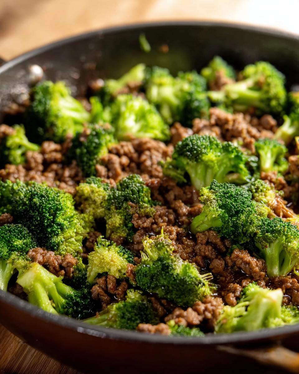 Close-up of a Keto Hamburger Broccoli Skillet in a pan, showing seasoned ground beef mixed with tender broccoli florets.