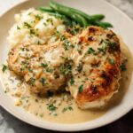 Parmesan Crusted Chicken with Creamy Garlic Sauce served with mashed potatoes and green beans.