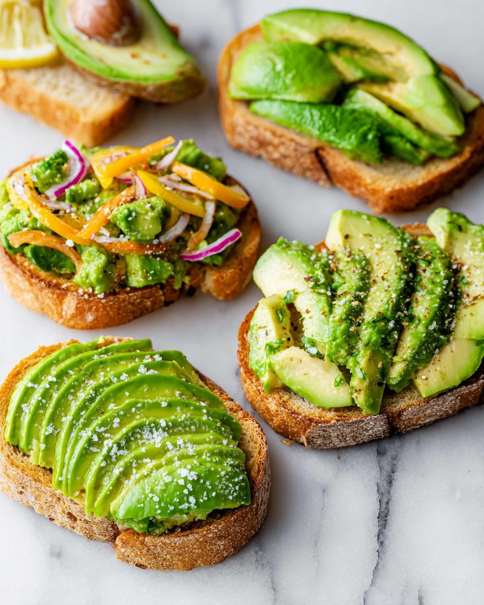 Four different variations of avocado toast on toasted bread, showcasing sliced and mashed avocado toppings.