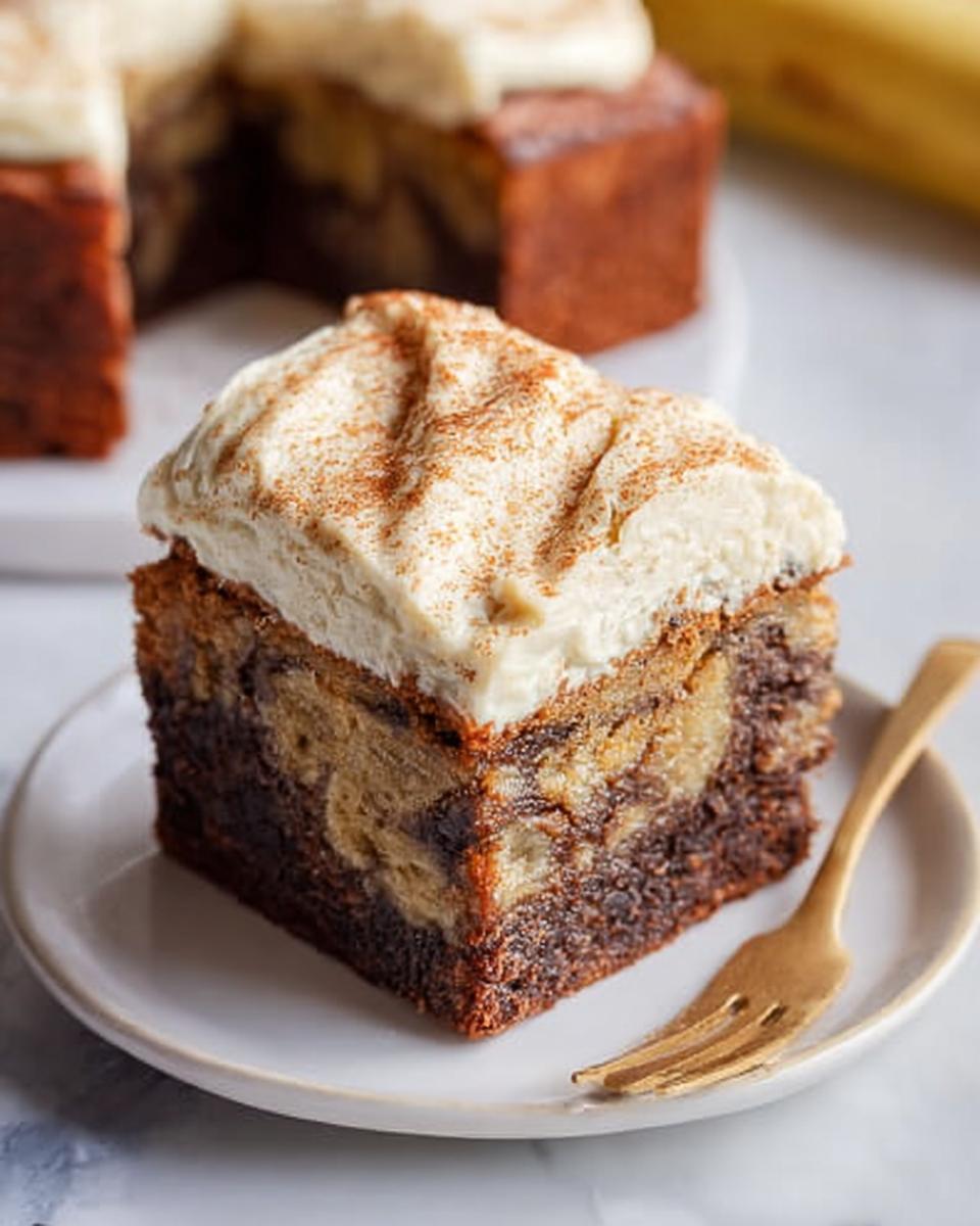 A slice of Banana Bread Brownies Made Easy, topped with cream cheese frosting and cinnamon.