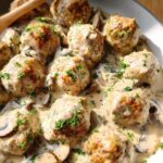Close-up of delicious Creamy Mushroom Chicken Meatballs covered in a rich sauce with sliced mushrooms and parsley.