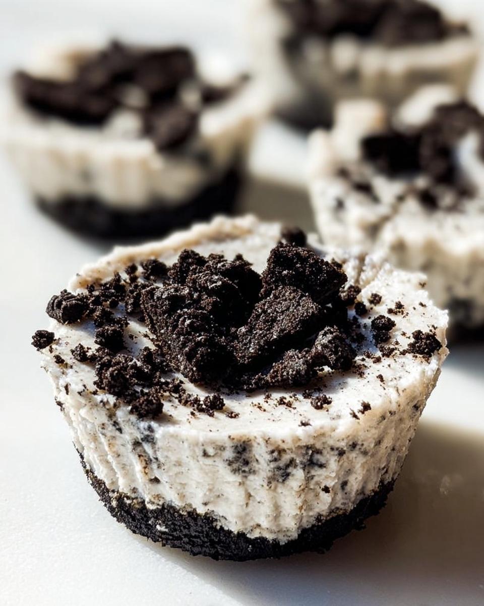 Close-up of a healthy no-bake Oreo cheesecake bite, topped with crushed Oreos.