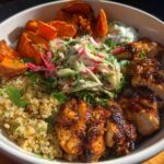 A vibrant Hot Honey Chicken Bowl featuring glazed chicken, quinoa, roasted sweet potatoes, and a fresh slaw.