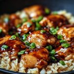 Close-up of One-Pan Honey BBQ Chicken Rice topped with chopped green onions.