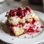 A decadent slice of Cherry Amaretto Tiramisu, featuring layers of ladyfingers, cream, and cherry compote.