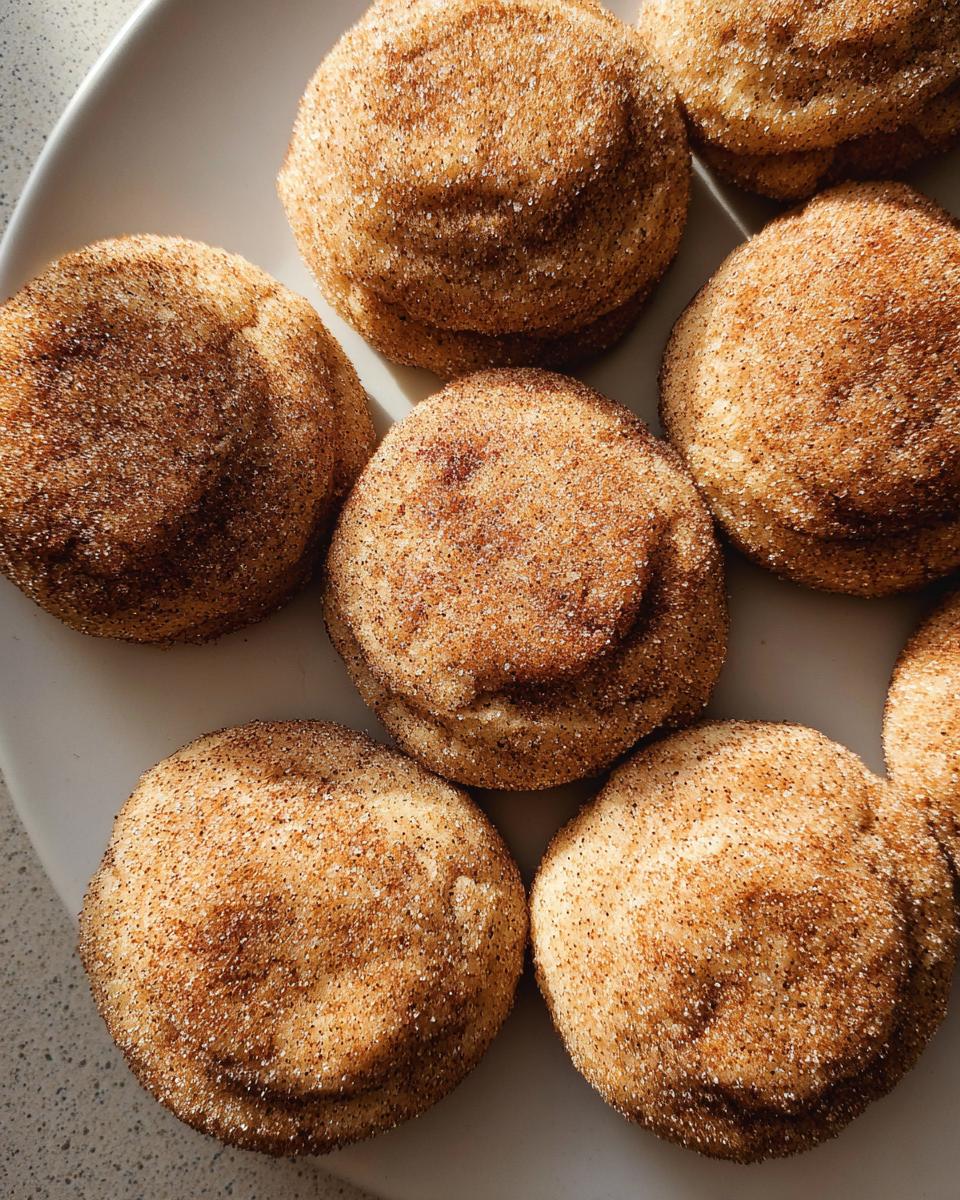 A close-up overhead shot of several Chewy Churro Cookies, generously coated in cinnamon sugar.
