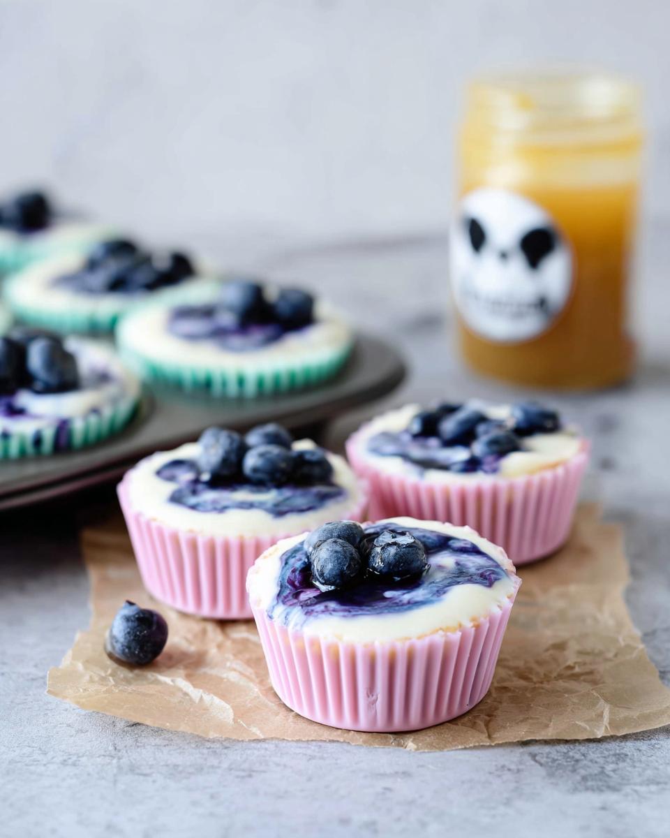 Close-up of easy blueberry swirl yogurt bites topped with fresh blueberries.